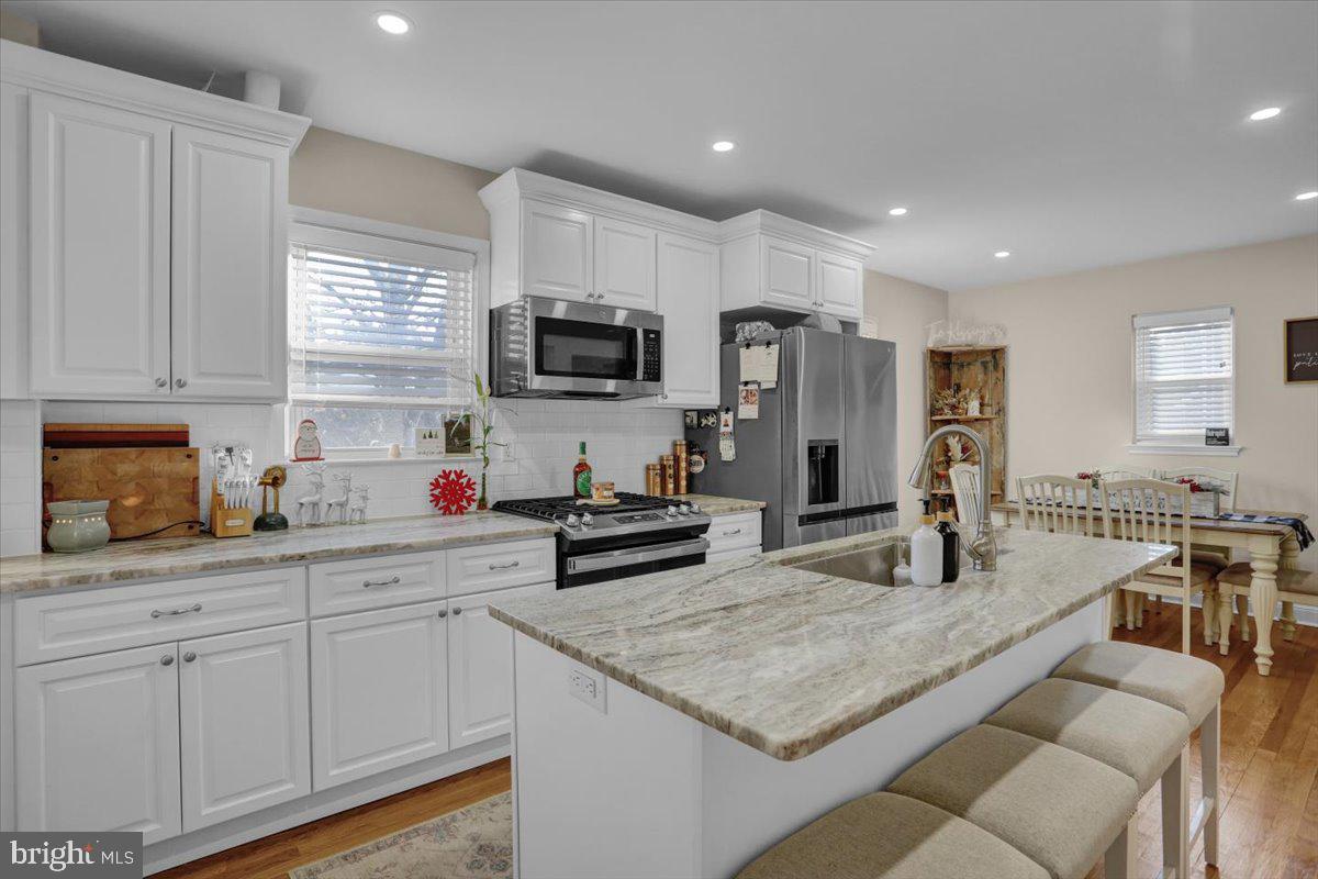 321 Jefferson Boulevard Reading, PA 19609 - Photo 10 of 32 a kitchen with granite countertop a sink white cabinets and stainless steel appliances