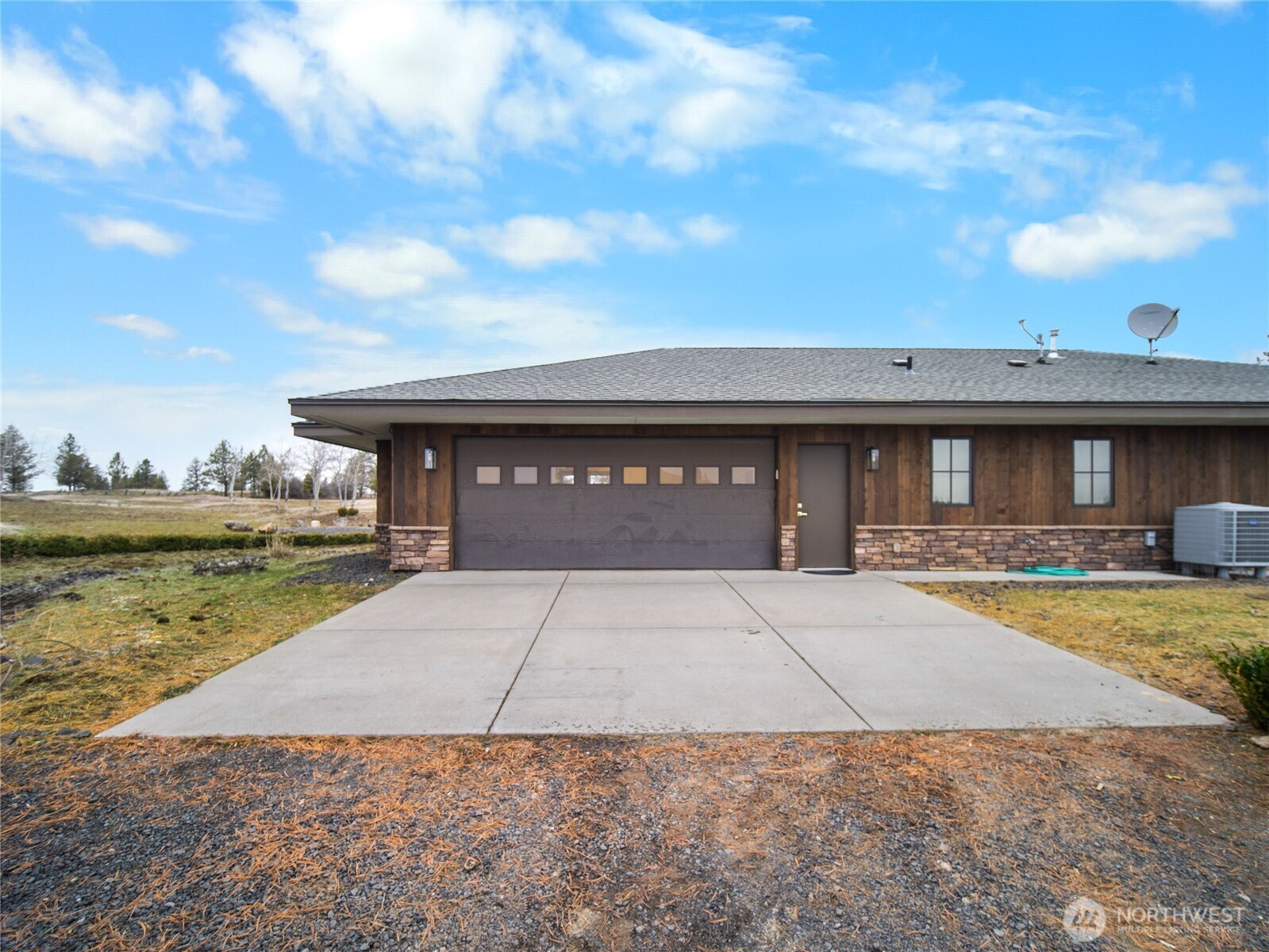 37227 South Long Road Cheney, WA 99004 - Photo 12 of 39 a front view of a house with swimming pool and a yard