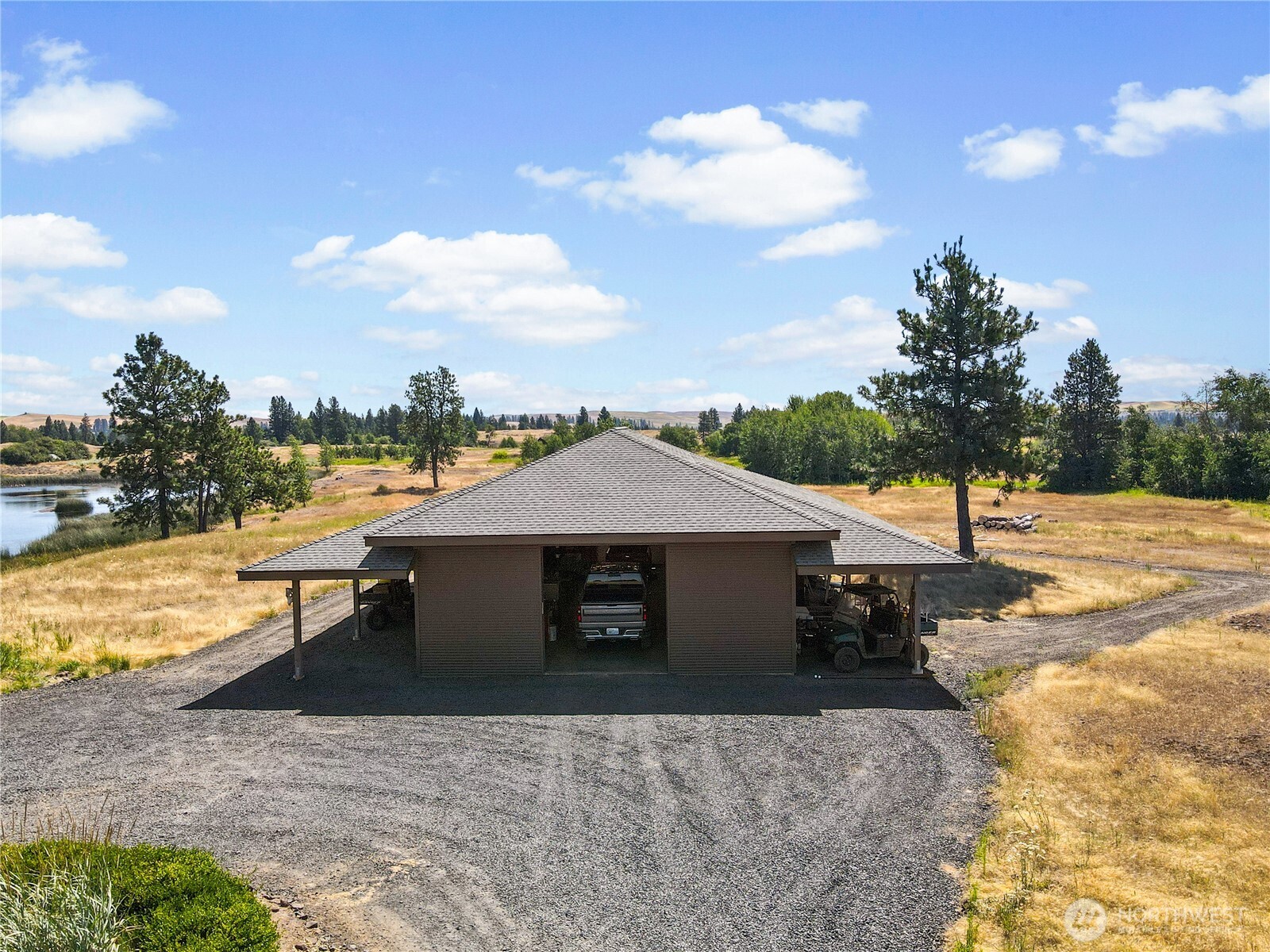37227 South Long Road Cheney, WA 99004 - Photo 16 of 39 a white house with a yard and ocean view