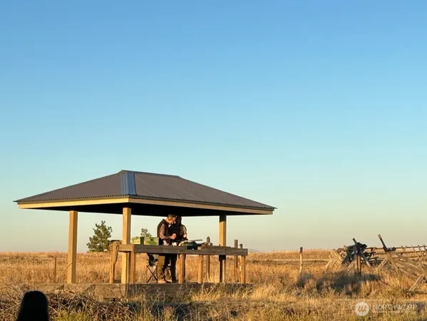 a blue umbrella with table and chairs