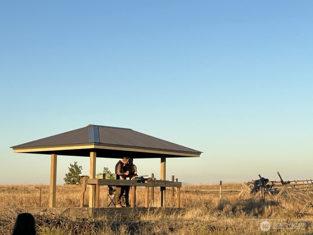 37227 South Long Road Cheney, WA 99004 - Photo 33 of 39 a blue umbrella with table and chairs