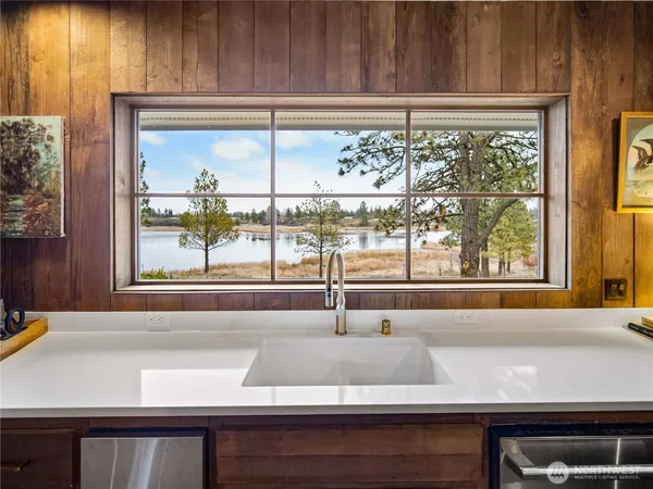 a kitchen with a sink and large window