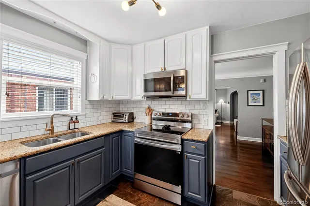 a kitchen with stainless steel appliances a stove sink microwave and cabinets