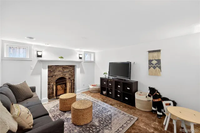a living room with furniture and a fireplace