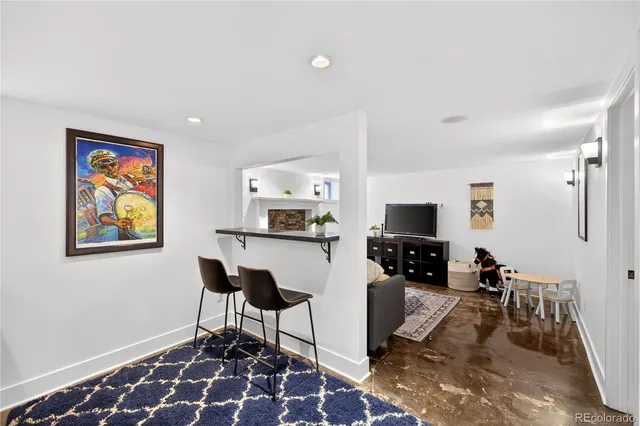 a living room with furniture a rug and a flat screen tv