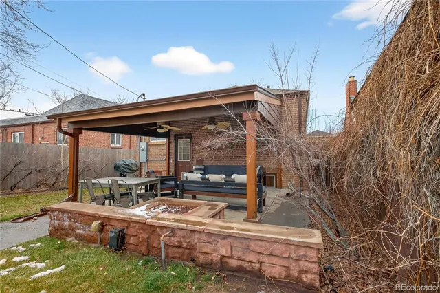 a view of a house with backyard and sitting area