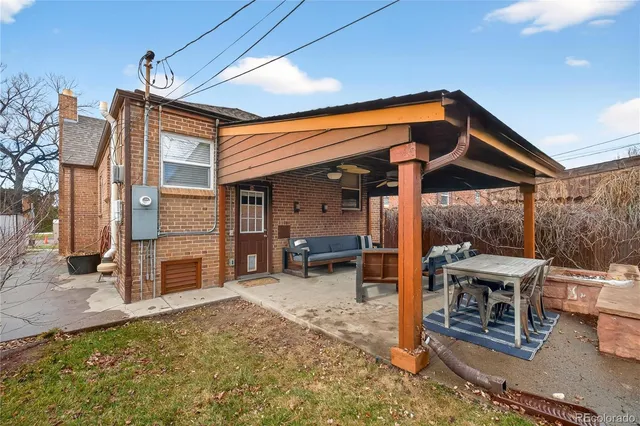 a view of a patio with table and chairs a barbeque with wooden fence