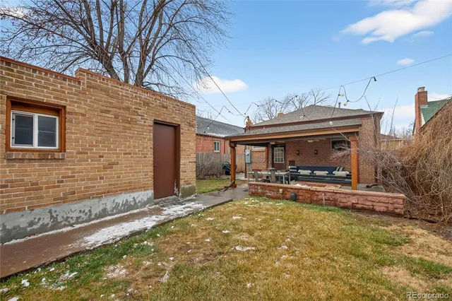 a backyard of a house with basket ball court and outdoor seating