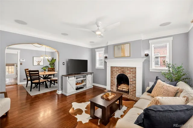 a living room with furniture fireplace and flat screen tv