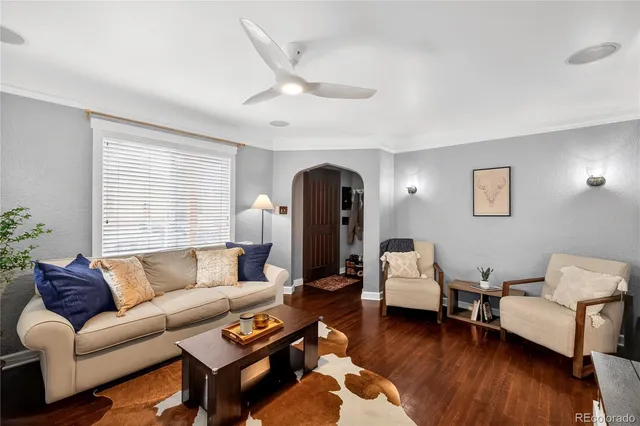 a living room with furniture and wooden floor