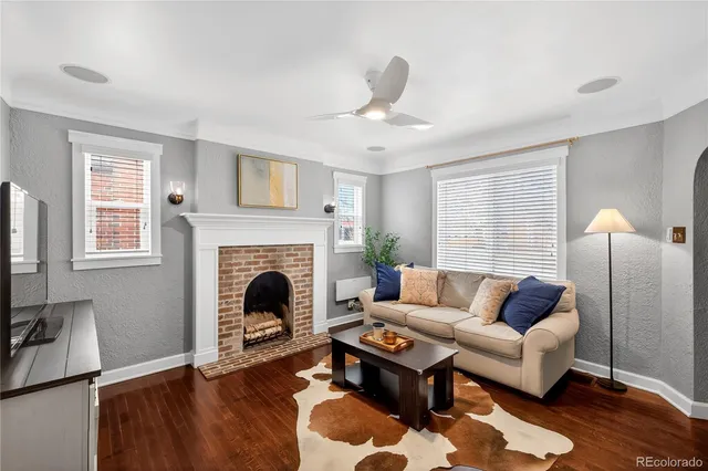 a living room with furniture and a fireplace