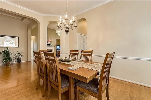 a view of a dining room with furniture and wooden floor