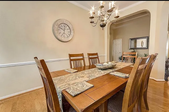 a view of a dining room with furniture and a chandelier