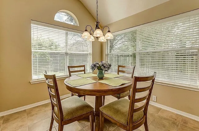 a dining room with furniture and window