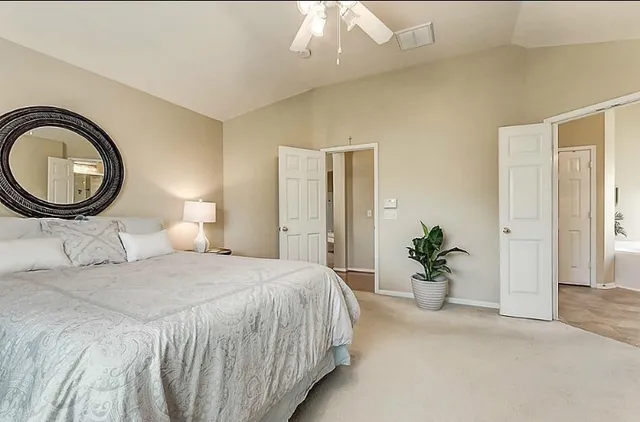 a bedroom with a bed and a chandelier