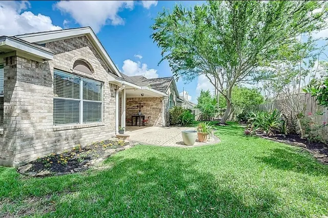 a front view of a house with a yard garage and outdoor seating