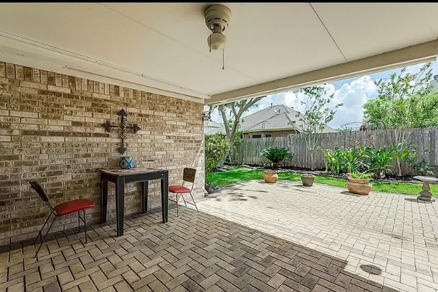 a view of a patio with table and chairs potted plants with wooden floor