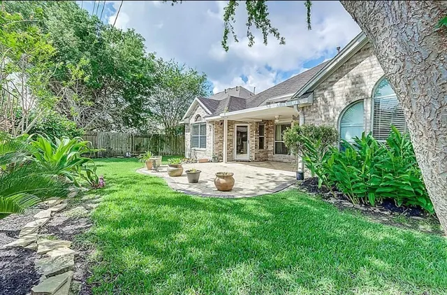 a view of an house with backyard porch and sitting area