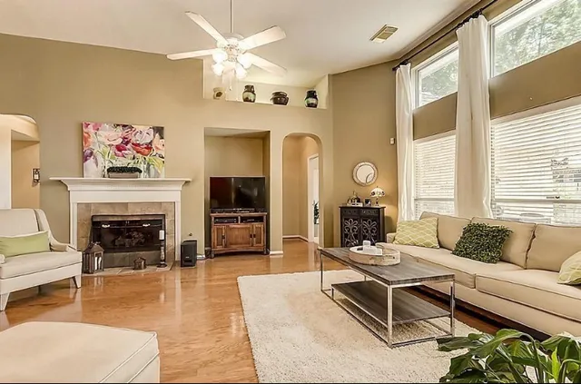 a living room with furniture a fireplace and a flat screen tv