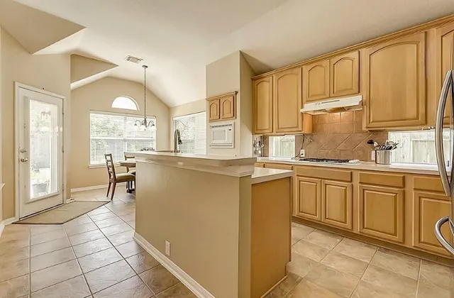 a kitchen with cabinets and window