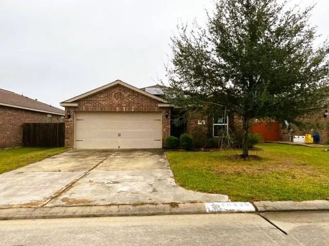 a front view of a house with a yard garage and outdoor seating