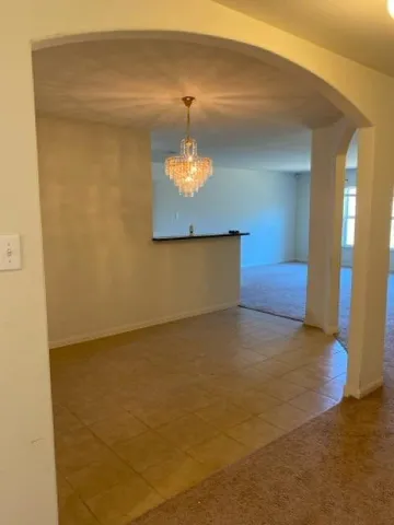 a view of a hallway with a chandelier