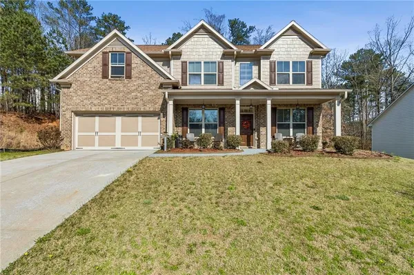 a front view of a house with a yard