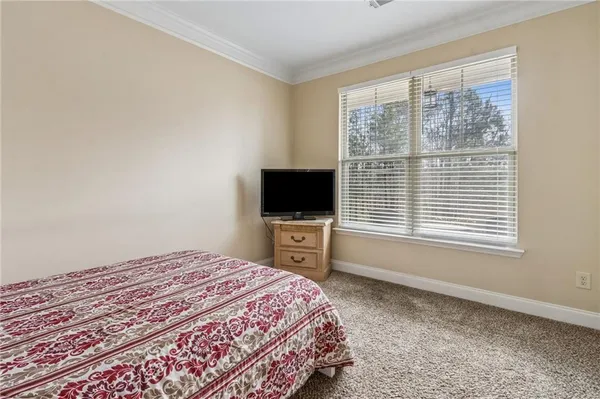a bedroom with a bed and chandelier