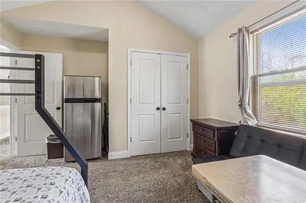 a bed sitting in a bedroom next to a window