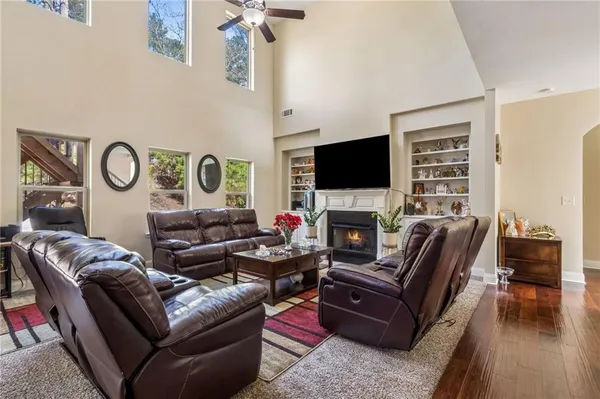 a living room with furniture a flat screen tv and a fireplace
