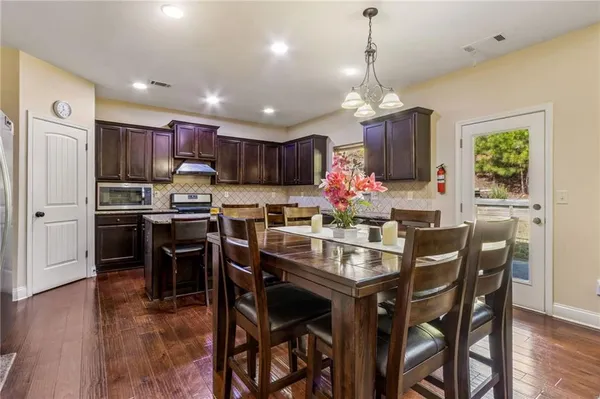 a view of a dining room with furniture window and wooden floor