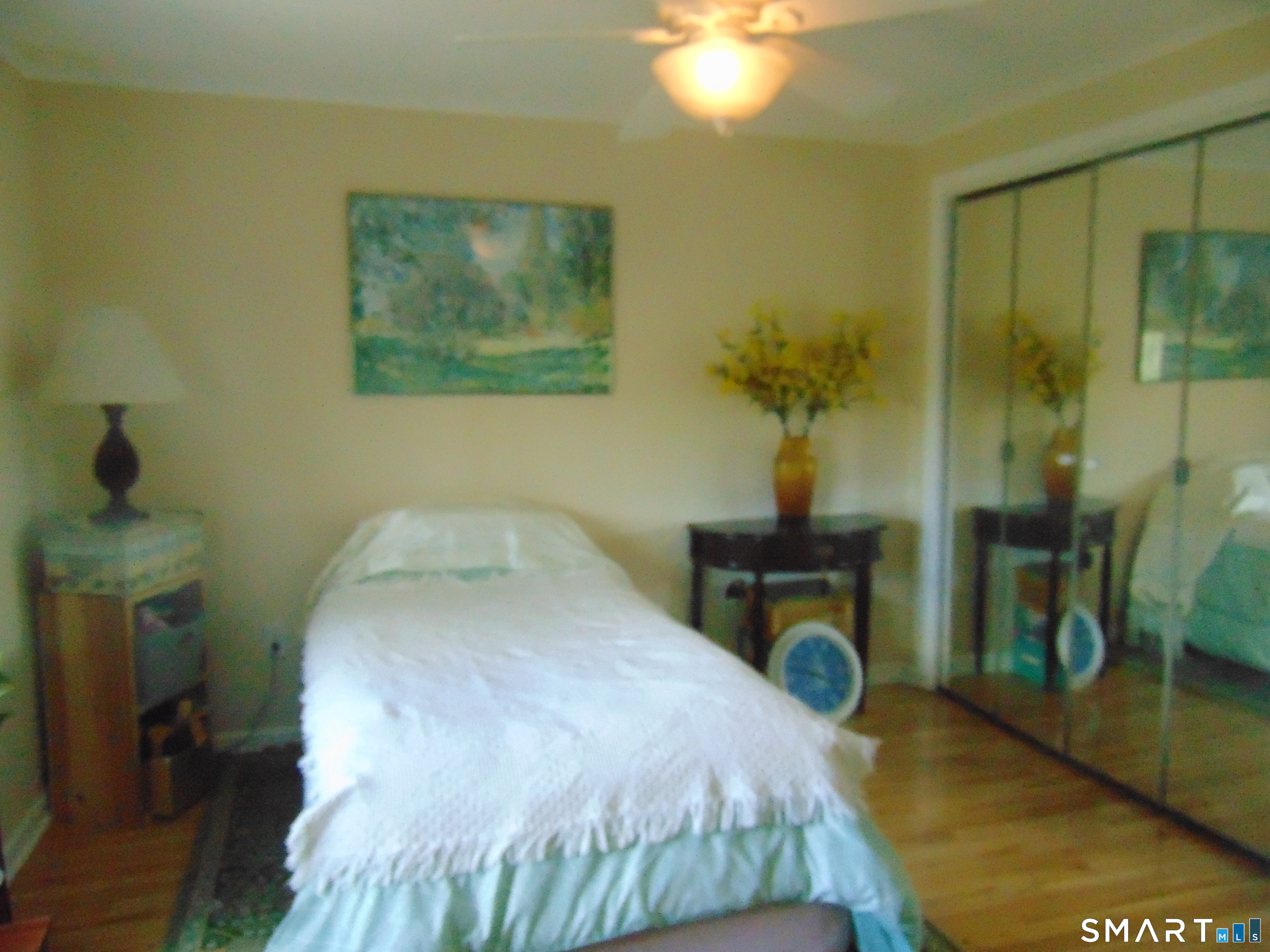 882 North Colony Road, Unit 31 Meriden, CT 06450 - Photo 24 of 34 a bedroom with a bed and a chandelier