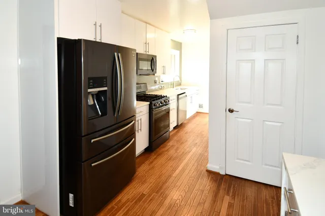 a kitchen with a refrigerator and window