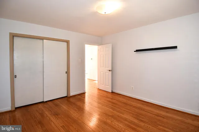 a kitchen with kitchen island wooden floor appliances and cabinets