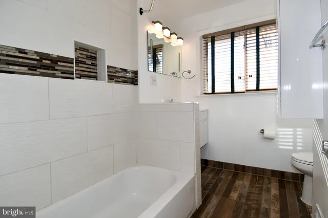 a view of empty room with wooden floor and fireplace