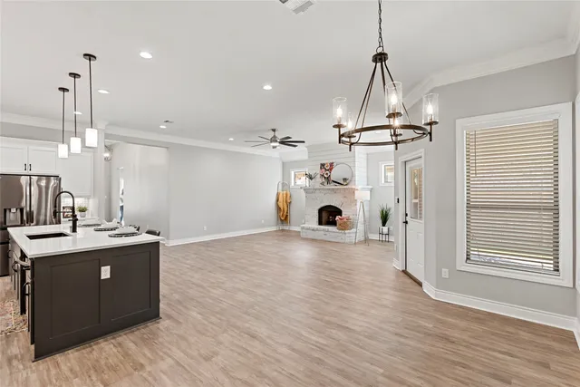 a view of kitchen and living room with wooden floor