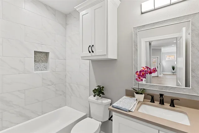 a bathroom with a sink toilet and shower