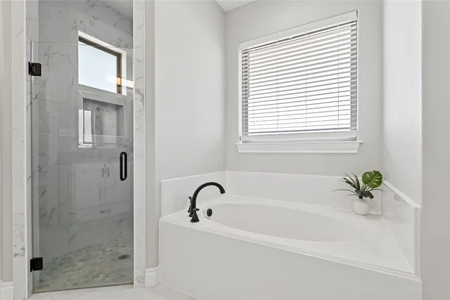 a white bath tub sitting next to a shower