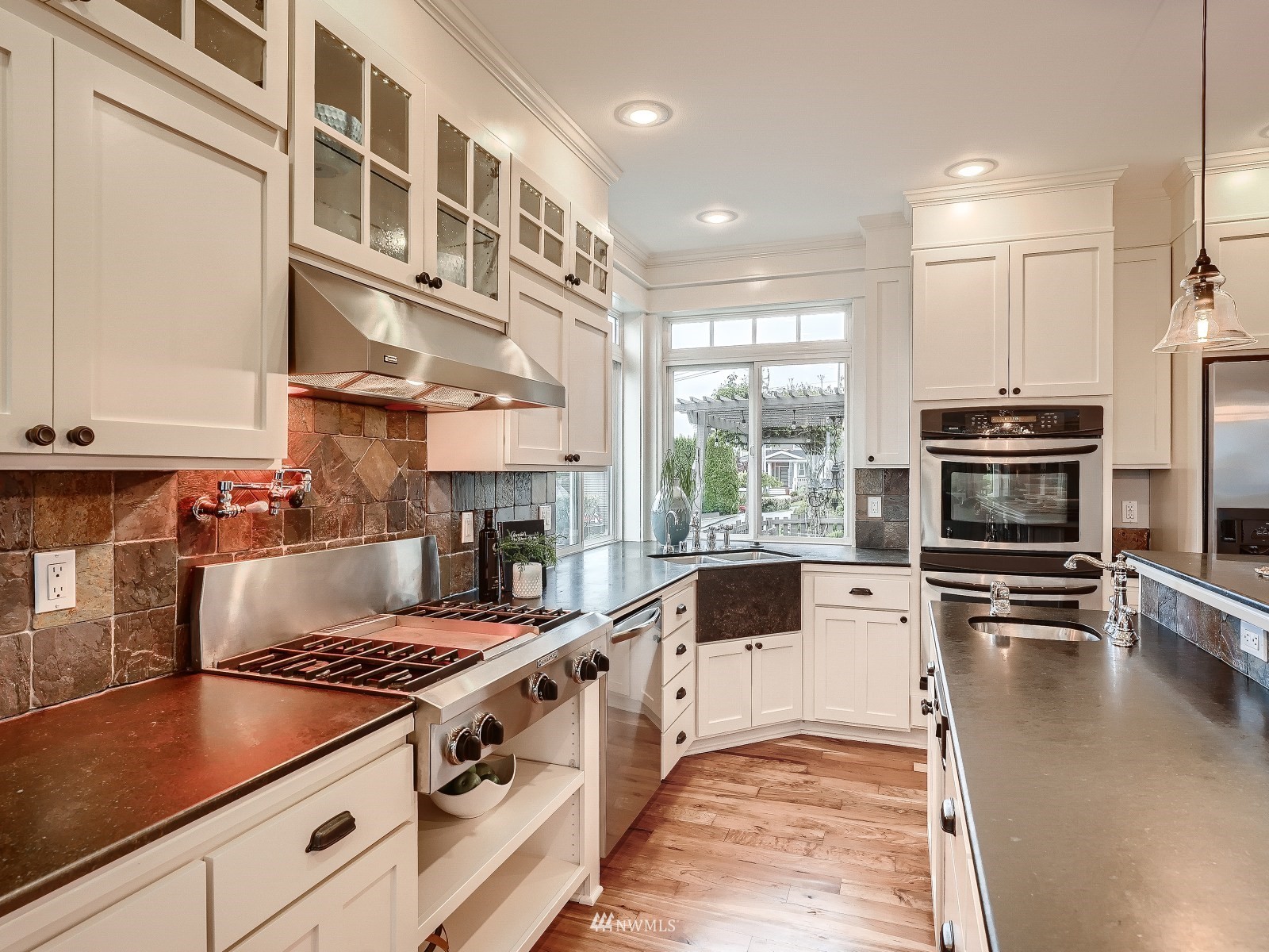 706 North 29th Street Renton, WA 98056 - Photo 11 of 37 a kitchen with stainless steel appliances granite countertop a stove and a sink