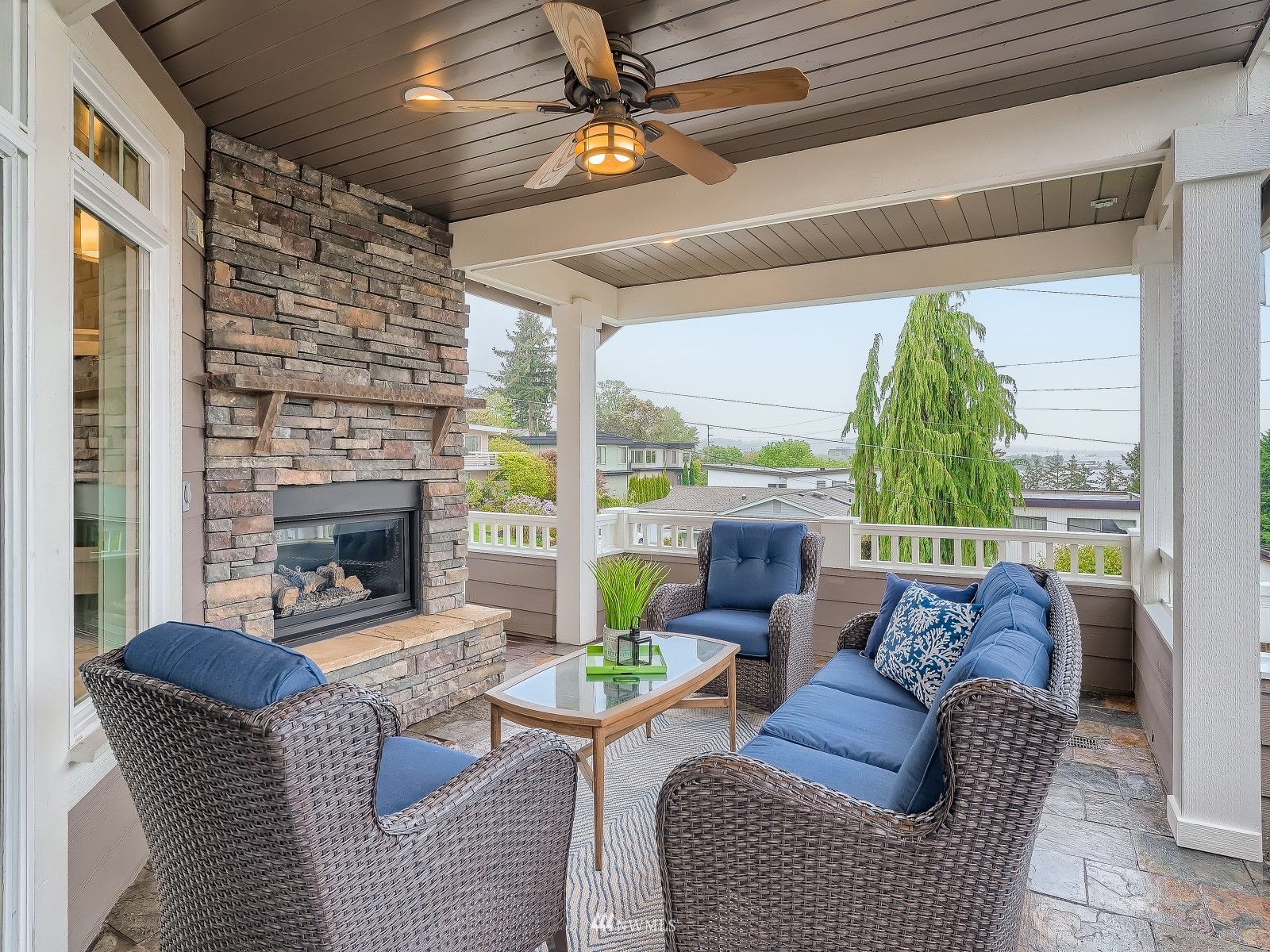 706 North 29th Street Renton, WA 98056 - Photo 14 of 37 a living room with furniture a fireplace and a floor to ceiling window