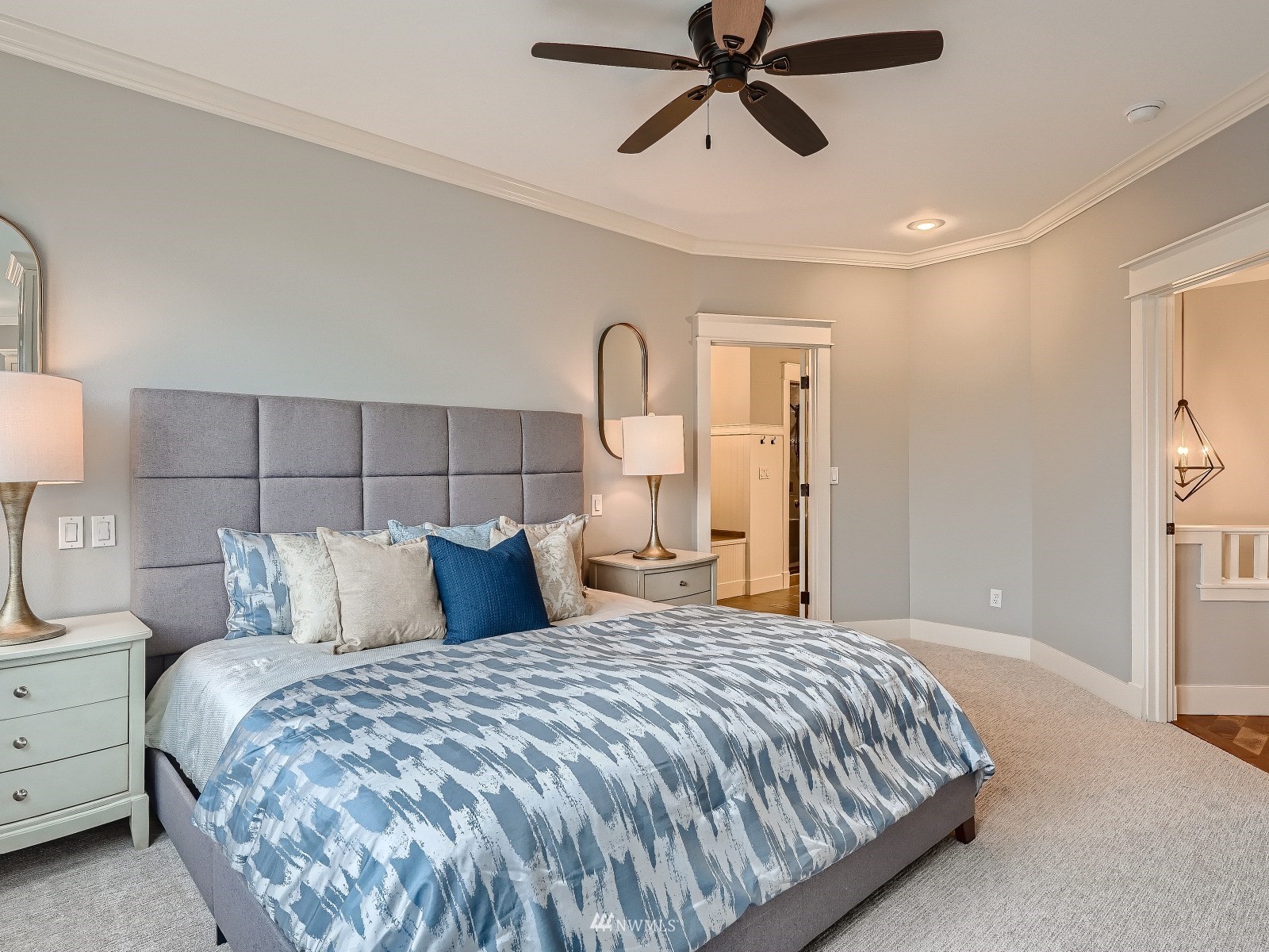 706 North 29th Street Renton, WA 98056 - Photo 16 of 37 a bedroom with a large bed and a chandelier