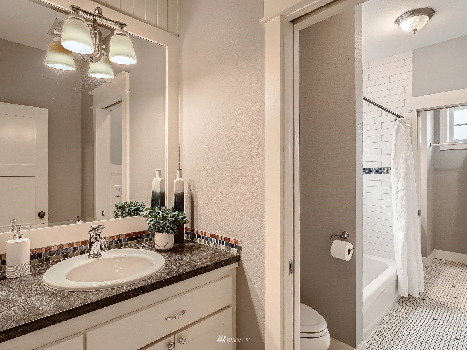 706 North 29th Street Renton, WA 98056 - Photo 24 of 37 a bathroom with a granite countertop sink a toilet and shower