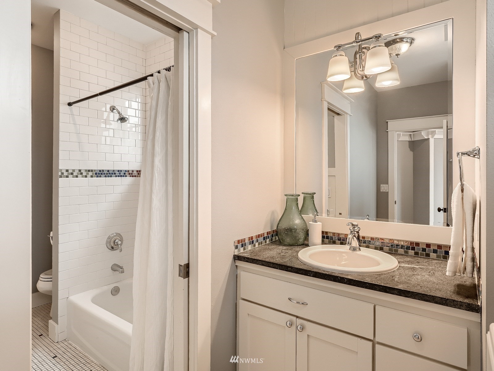 706 North 29th Street Renton, WA 98056 - Photo 25 of 37 a bathroom with a granite countertop sink shower and a mirror