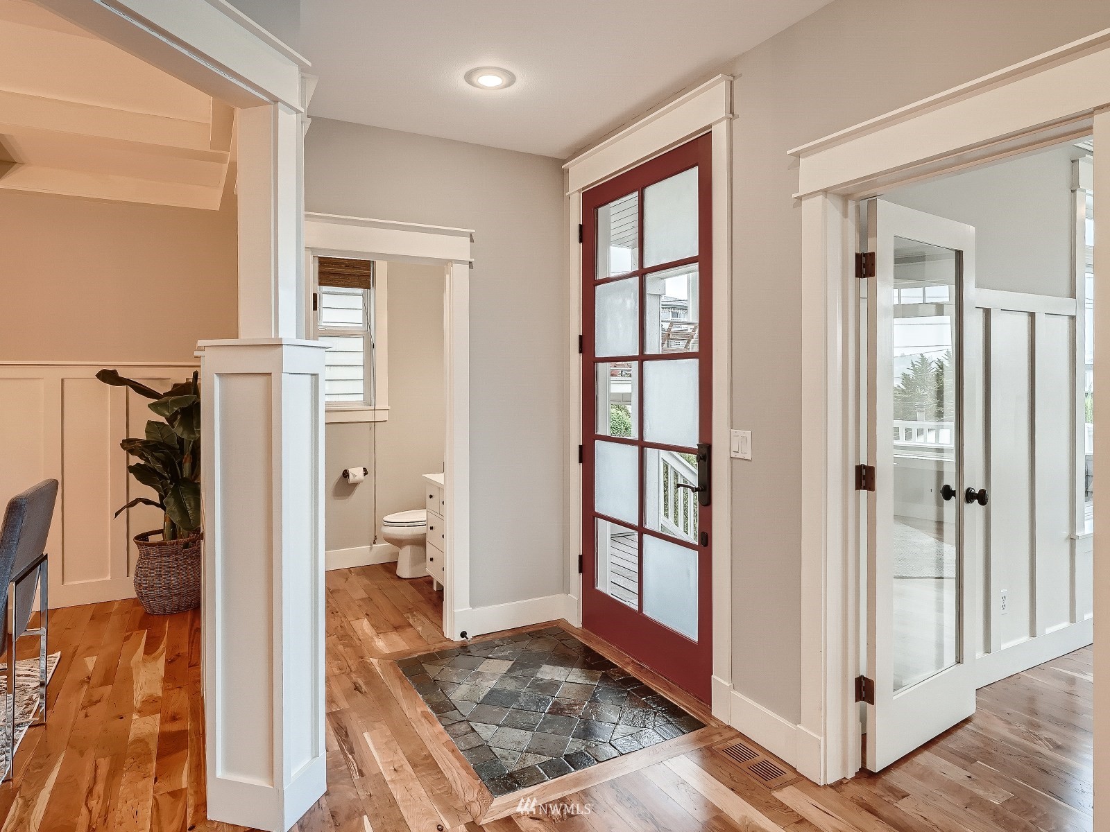 706 North 29th Street Renton, WA 98056 - Photo 3 of 37 a view of a hallway with bathroom and wooden floor