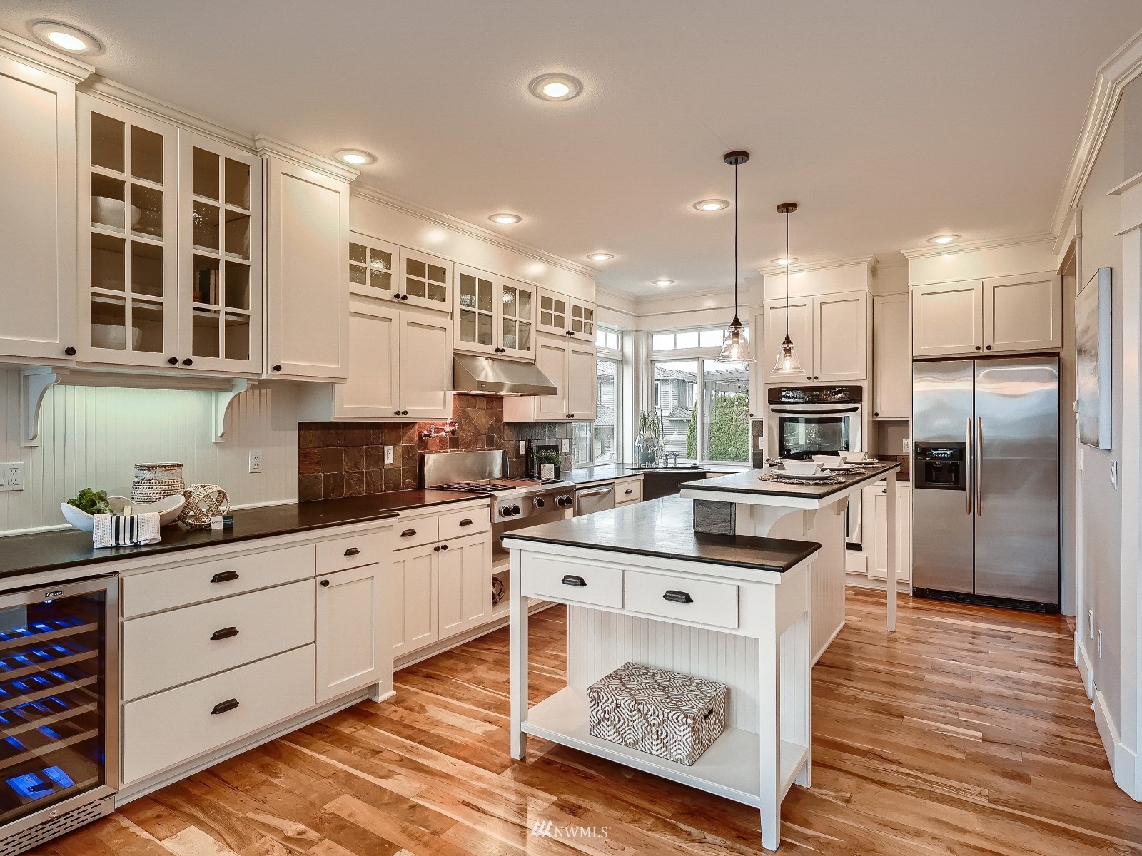 706 North 29th Street Renton, WA 98056 - Photo 9 of 37 a kitchen with stainless steel appliances kitchen island granite countertop a sink and cabinets