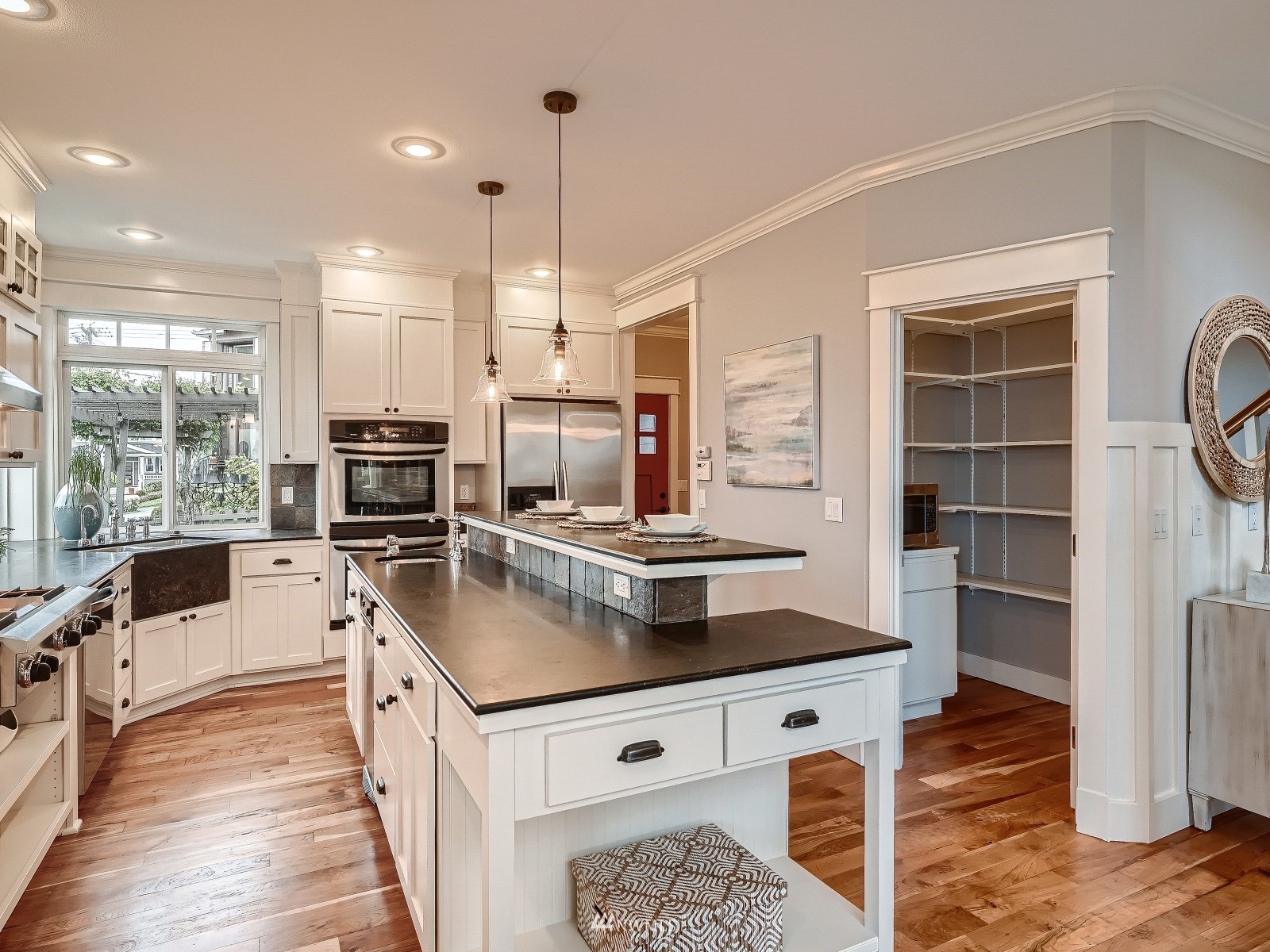 706 North 29th Street Renton, WA 98056 - Photo 10 of 37 a kitchen with stainless steel appliances granite countertop a stove a sink and a refrigerator