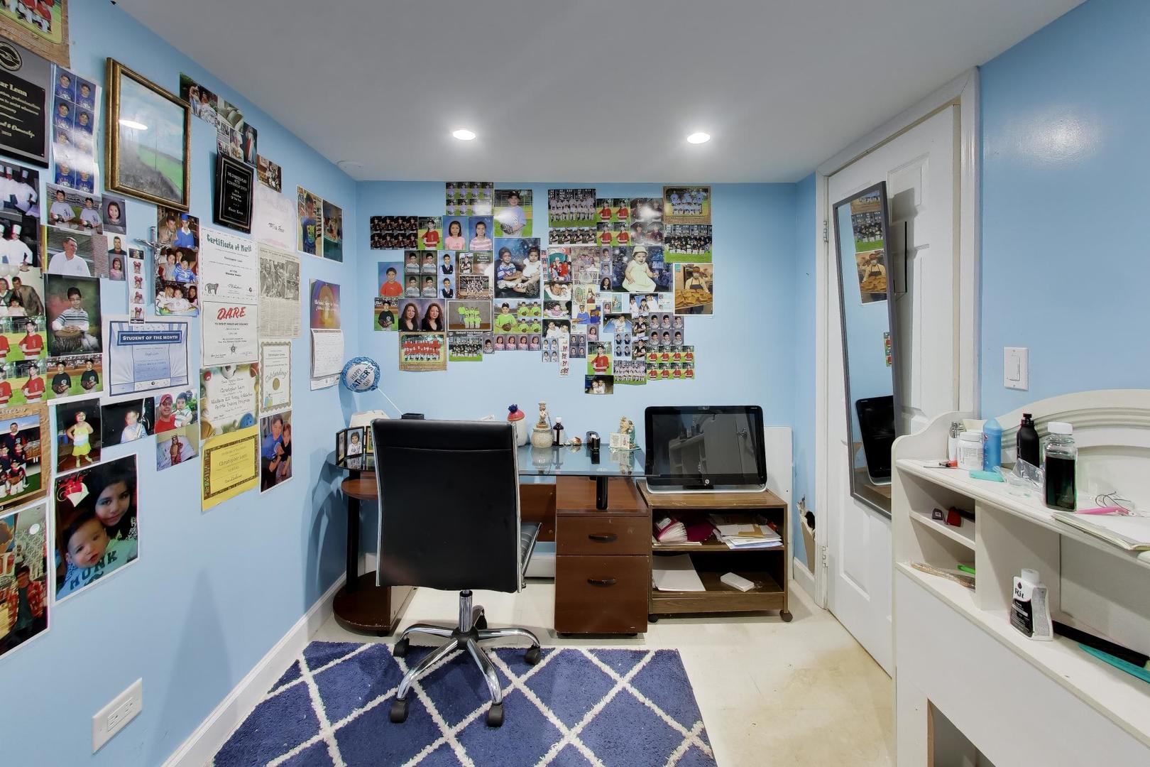 458 West Alma Street Elmhurst, IL 60126 - Photo 23 of 29 a room with furniture and a flat screen tv