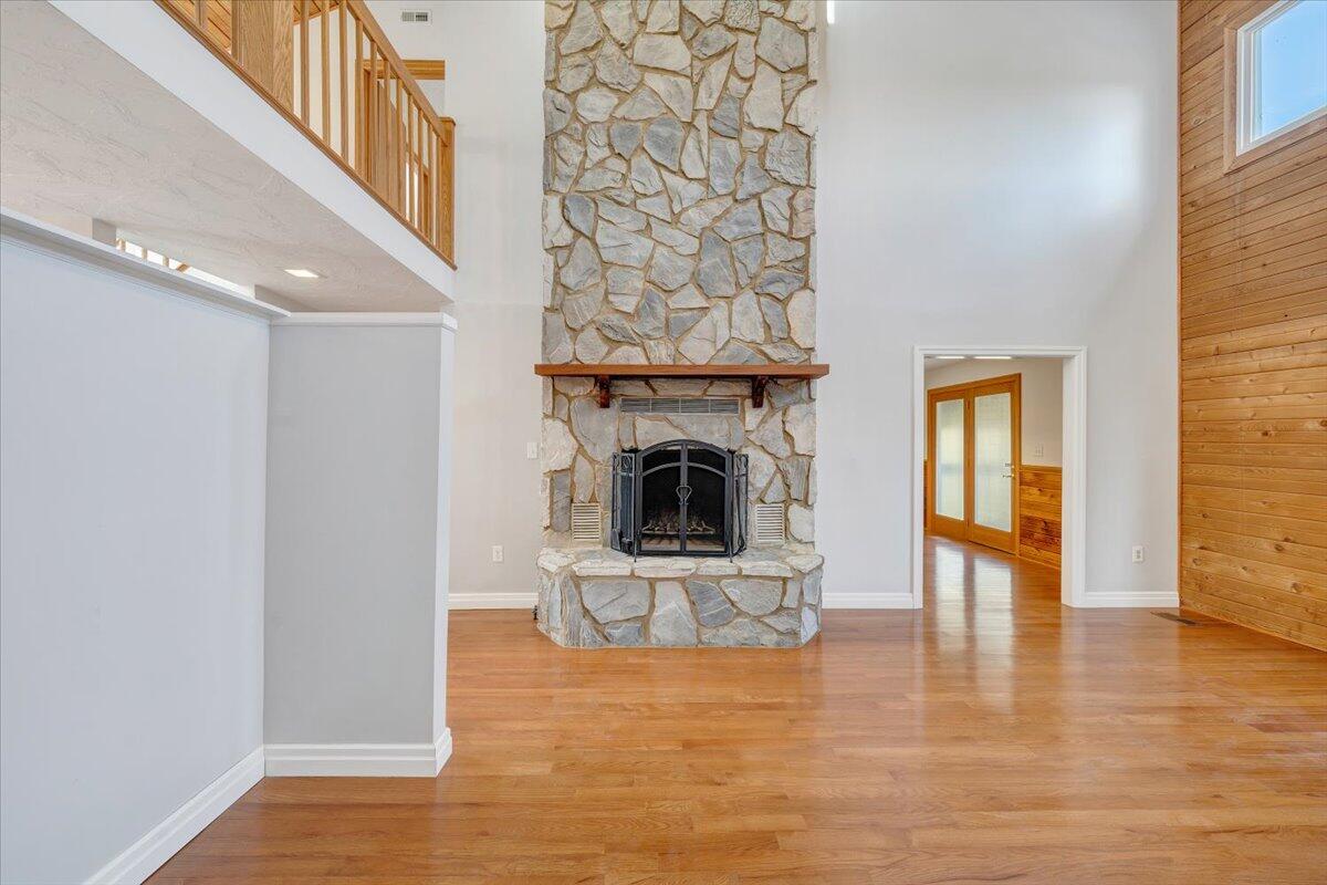 465 Summit Ridge Road Southwest Christiansburg, VA 24073 - Photo 7 of 79 a view of a livingroom with a fireplace a chandelier and wooden floor