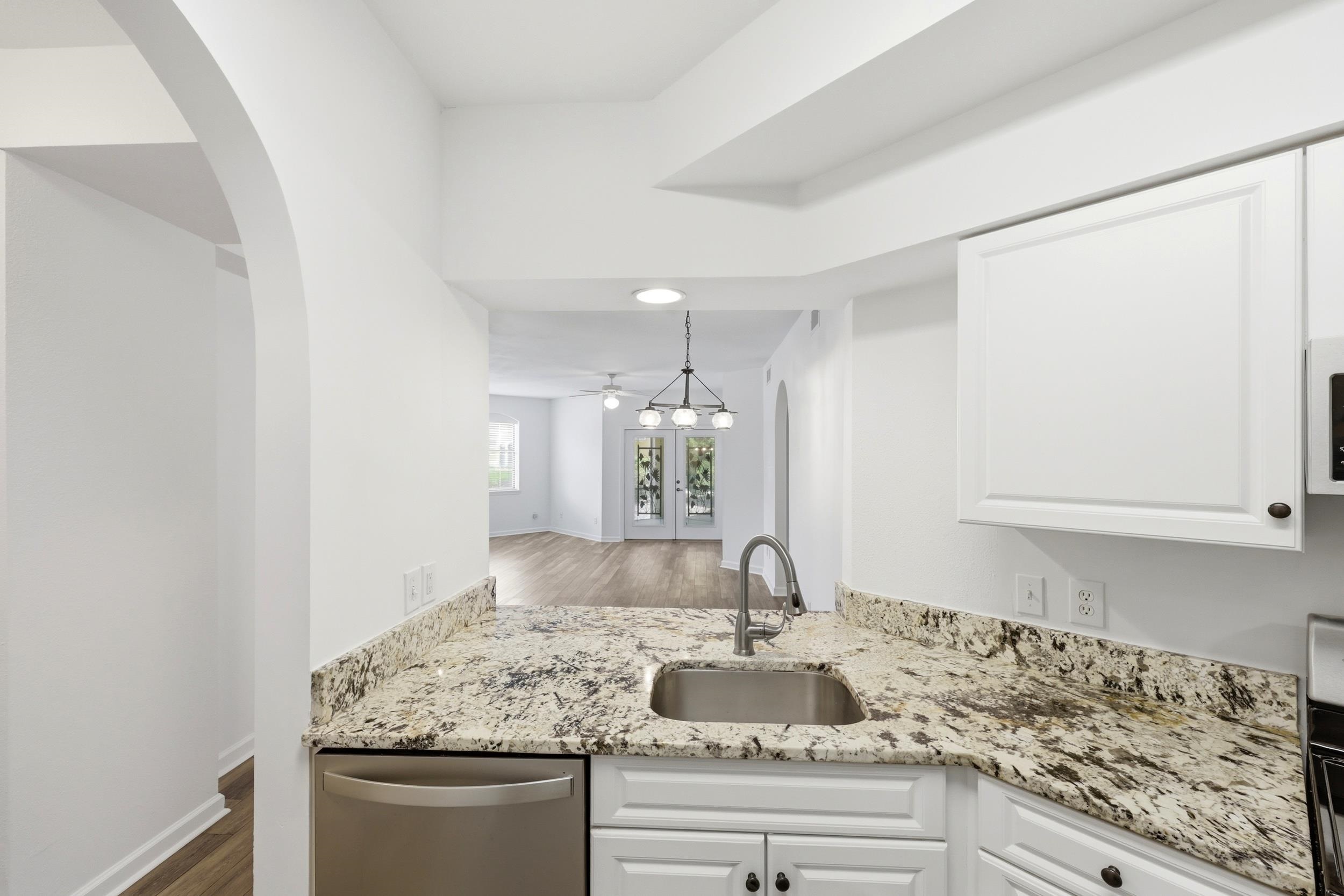 2500 Vista Cove Road St. Augustine, FL 32084 - Photo 12 of 53 a kitchen with granite countertop a sink and cabinets