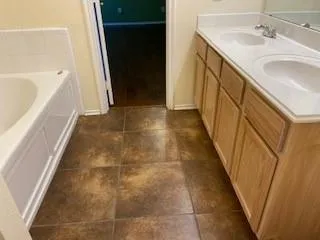 an empty room with wooden floor and a window